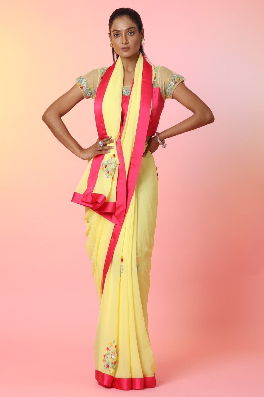 Shop beautiful yellow embroidered georgette saree online in USA with pink saree blouse. Look perfect in ethnic style on special occasions in beautiful designer sarees, embroidered sarees, party sarees, Bollywood sarees, handloom sarees from Pure Elegance Indian saree store in USA.-full view