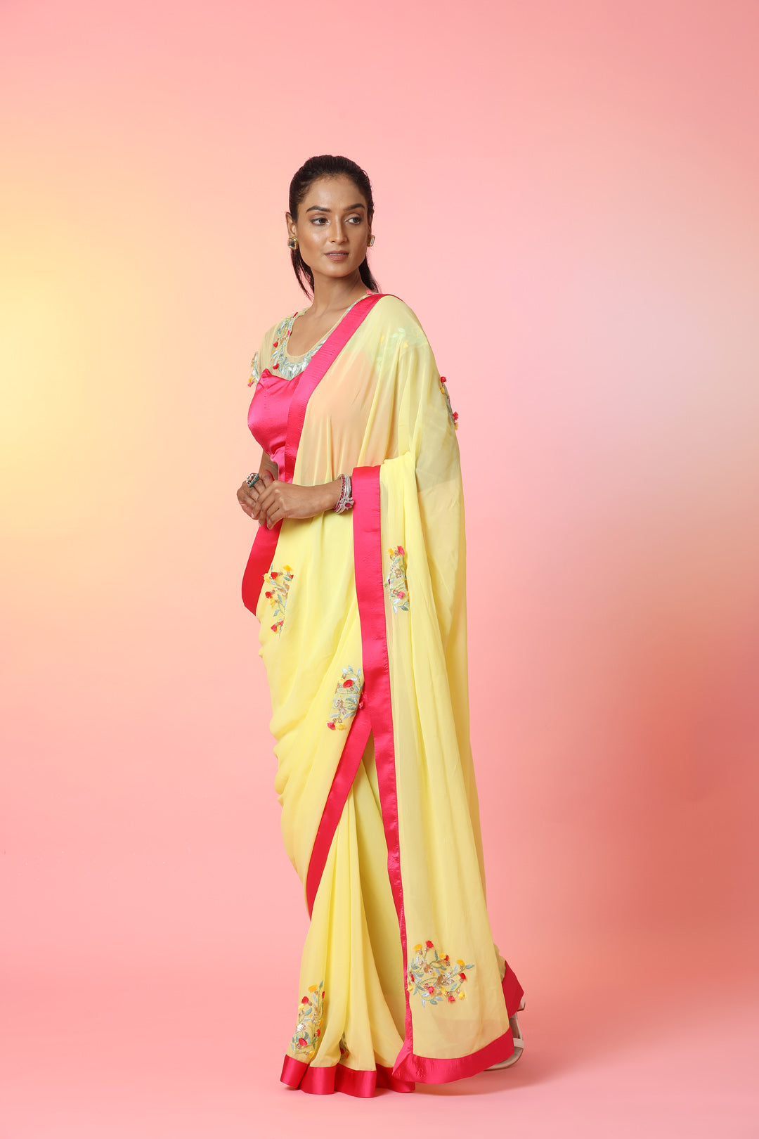 Shop beautiful yellow embroidered georgette saree online in USA with pink saree blouse. Look perfect in ethnic style on special occasions in beautiful designer sarees, embroidered sarees, party sarees, Bollywood sarees, handloom sarees from Pure Elegance Indian saree store in USA.-pallu