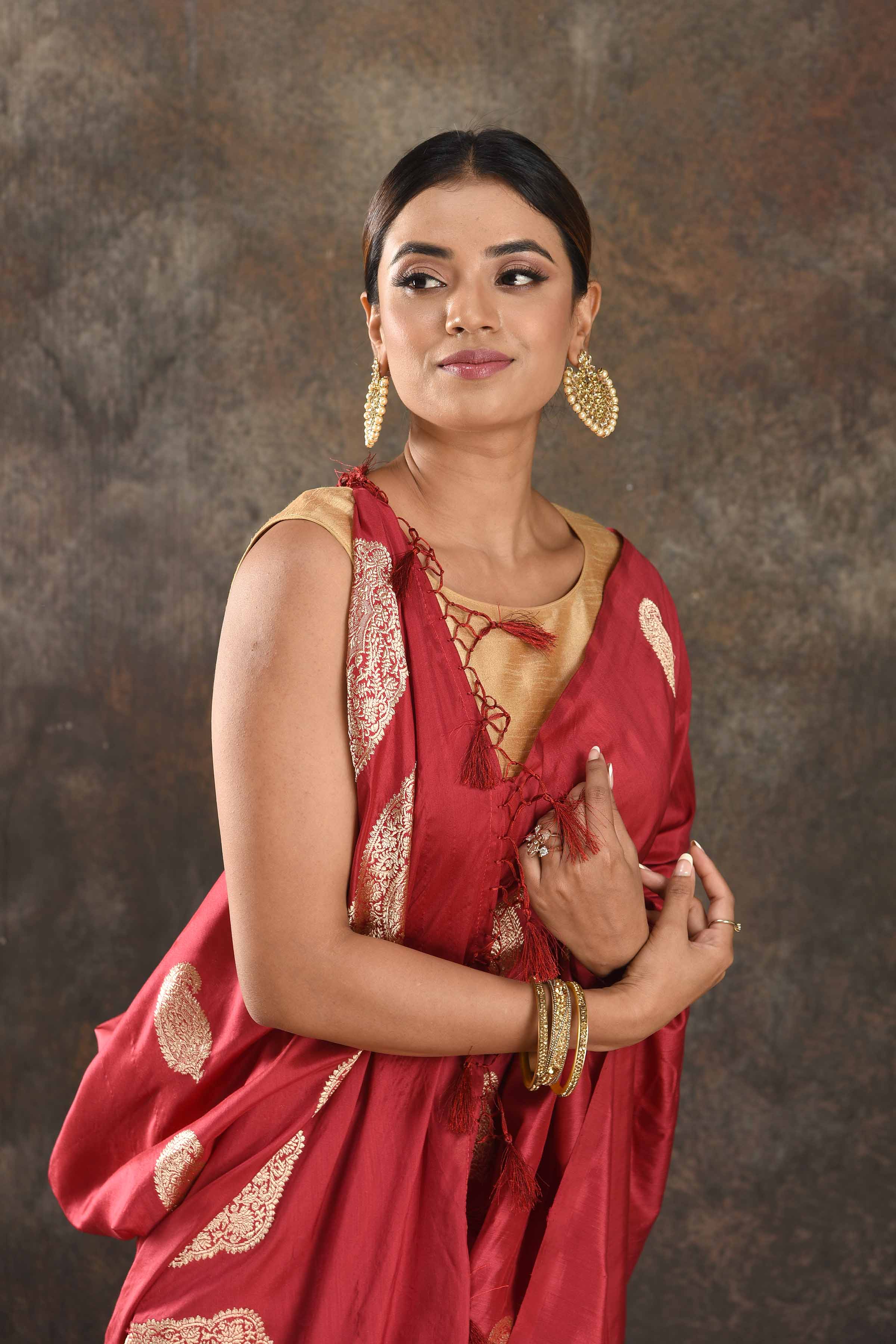 Buy beautiful red silk saree online in USA with silver zari paisley buta. Be vision of elegance on special occasions in exquisite designer sarees, handwoven sarees, georgette sarees, embroidered sarees, Banarasi sarees from Pure Elegance Indian saree store in USA.-closeup
