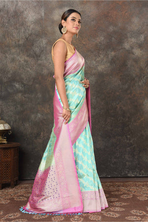 Buy beautiful pastel green Banarasi Mashru silk saree online in USA with pink border. Radiate elegance on special occasions in exquisite designer sarees, handwoven sarees, georgette sarees, embroidered sarees, Banarasi saree, pure silk saris, tussar sarees from Pure Elegance Indian saree store in USA.-side