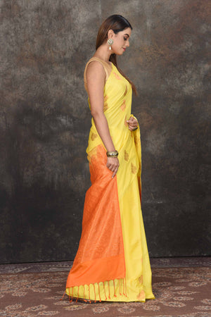 Buy beautiful light yellow Kanjivaram soft silk saree online in USA with orange zari pallu. Be the center of attraction on special occasions in ethnic sarees, designer sarees, embroidered sarees, handwoven sarees, pure silk sarees from Pure Elegance Indian saree store in USA.-side