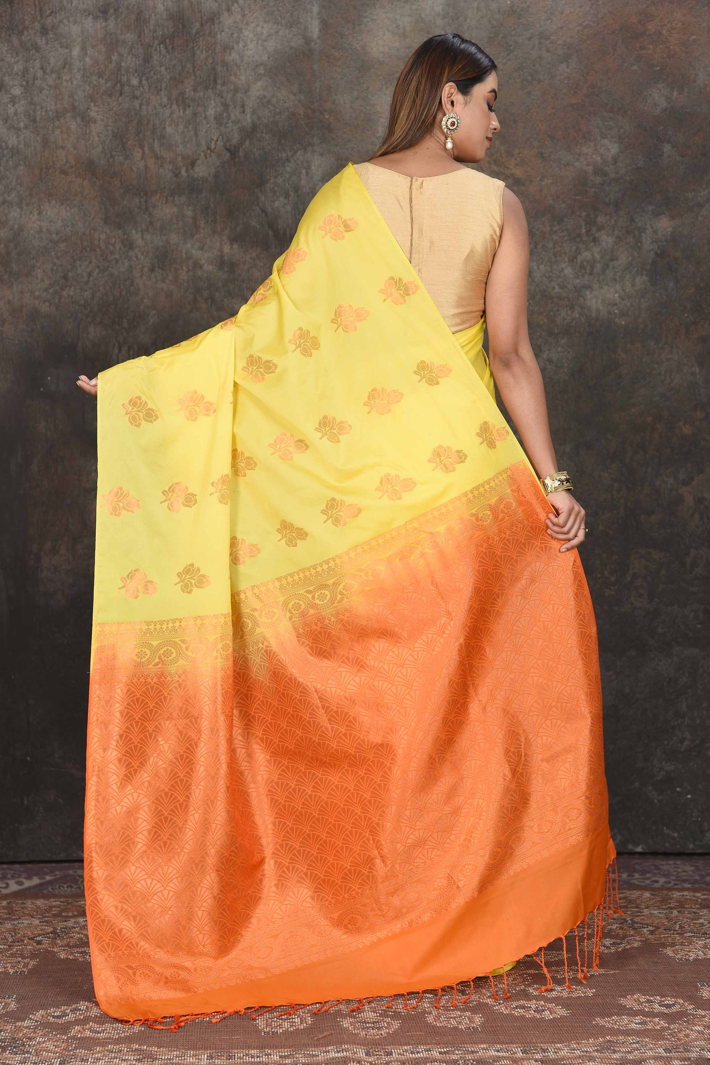 Buy beautiful light yellow Kanjivaram soft silk saree online in USA with orange zari pallu. Be the center of attraction on special occasions in ethnic sarees, designer sarees, embroidered sarees, handwoven sarees, pure silk sarees from Pure Elegance Indian saree store in USA.-back