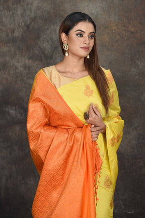Buy beautiful light yellow Kanjivaram soft silk saree online in USA with orange zari pallu. Be the center of attraction on special occasions in ethnic sarees, designer sarees, embroidered sarees, handwoven sarees, pure silk sarees from Pure Elegance Indian saree store in USA.-closeup