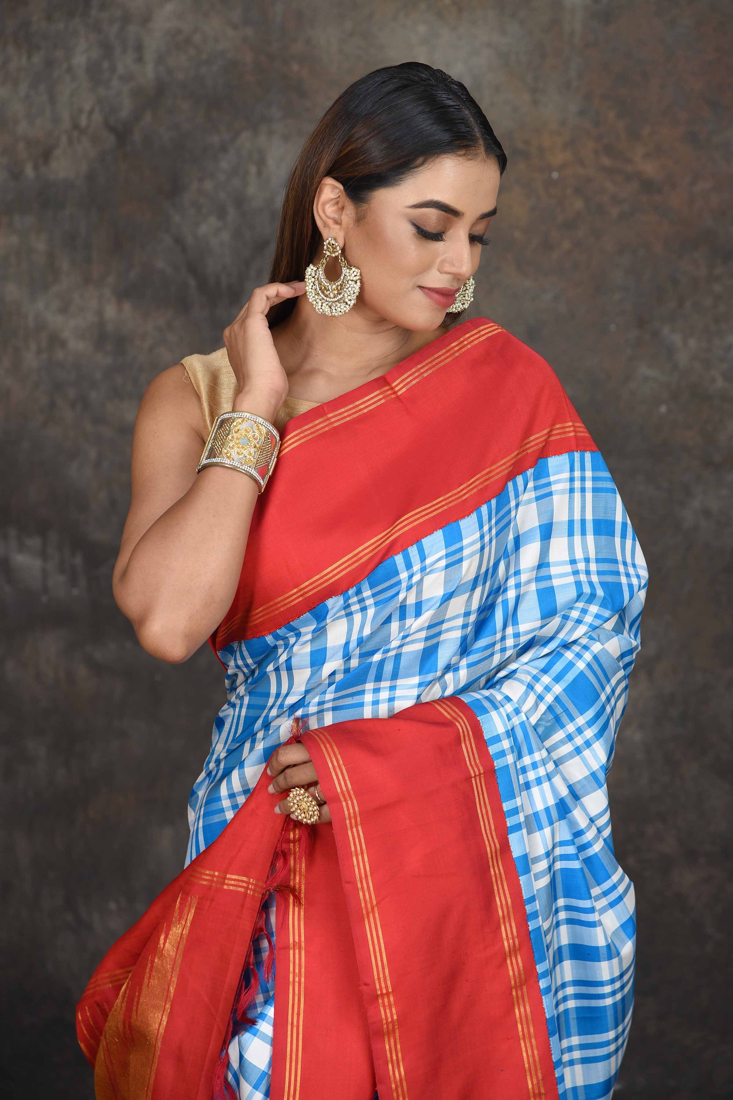 Buy beautiful white and blue check Kanjeevaram sari online in USA with red zari border. Go for a rich traditional look on weddings and festive occasions in pure silk sarees, Kanchipuram silk sarees, handloom sarees, Banarasi sarees from Pure Elegance Indian fashion store in USA.-closeup