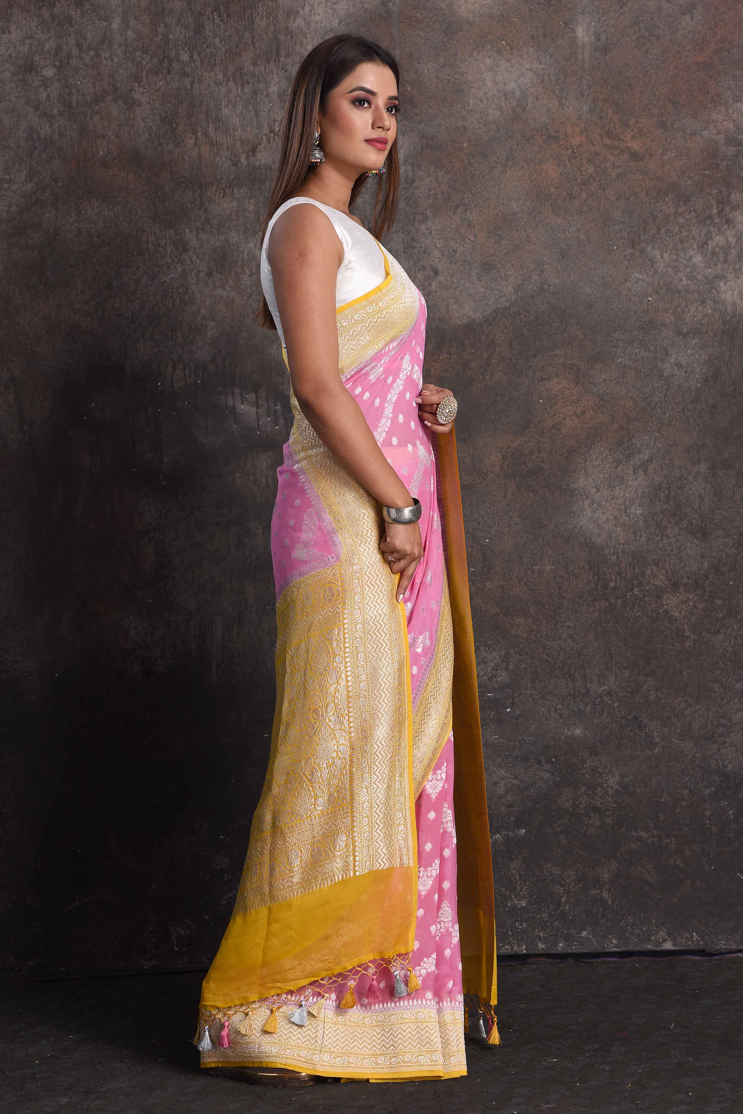Buy beautiful pastel pink georgette Banarasi saree online in USA with mustard border, Be a vision of ethnic elegance on festive occasions in beautiful designer sarees, silk sarees, handloom sarees, Kanchipuram silk sarees, embroidered sarees from Pure Elegance Indian saree store in USA. -side