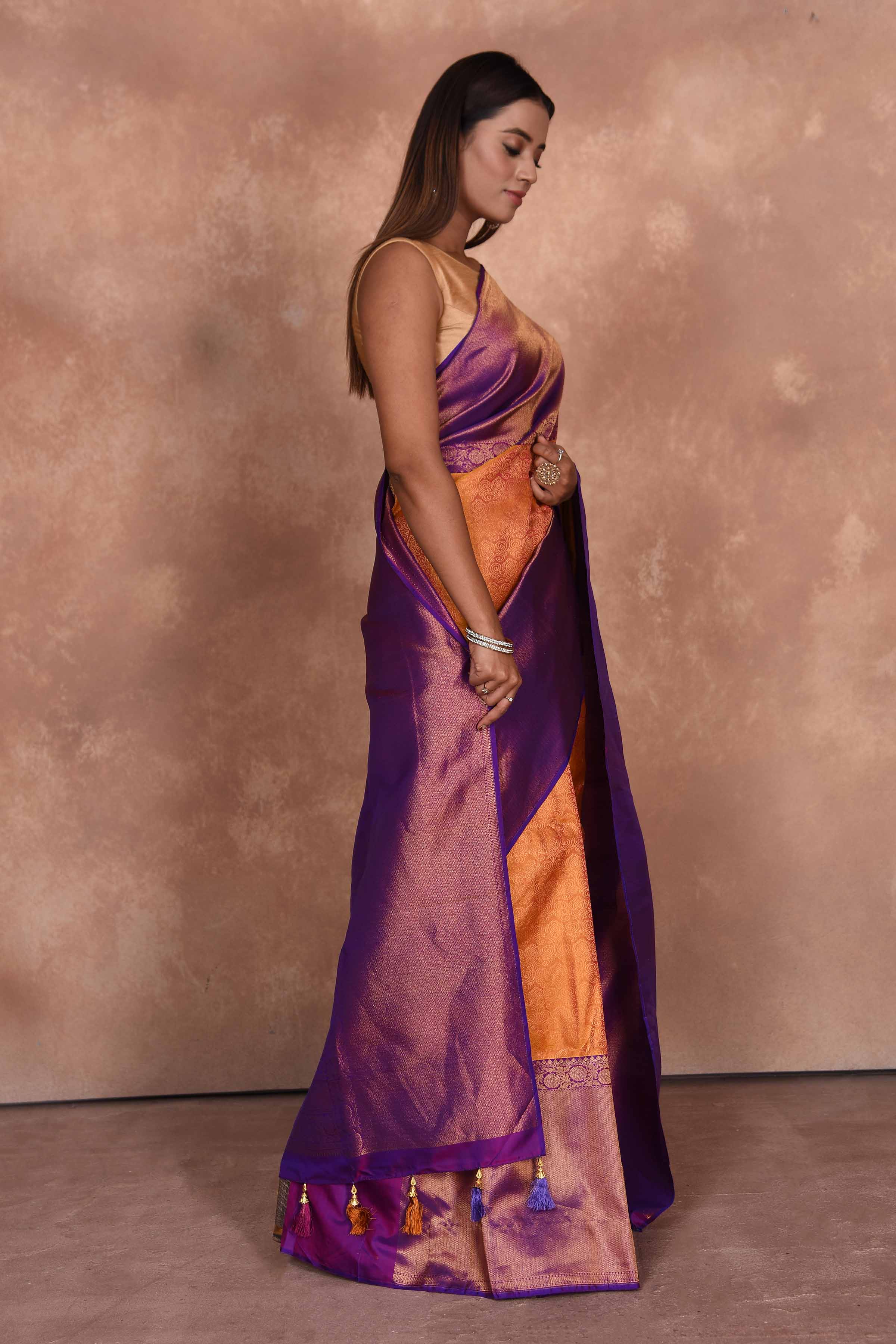 Buy orange Kanjeevaram silk sari online in USA with purple zari border. Keep your ethnic wardrobe up to date with latest designer sarees, pure silk saris, Kanchipuram silk sarees, handwoven sarees, tussar silk saris, embroidered sarees, soft silk sarees, Kora silk sarees from Pure Elegance Indian saree store in USA.-side