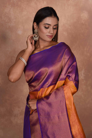 Buy orange Kanjeevaram silk sari online in USA with purple zari border. Keep your ethnic wardrobe up to date with latest designer sarees, pure silk saris, Kanchipuram silk sarees, handwoven sarees, tussar silk saris, embroidered sarees, soft silk sarees, Kora silk sarees from Pure Elegance Indian saree store in USA.-closeup