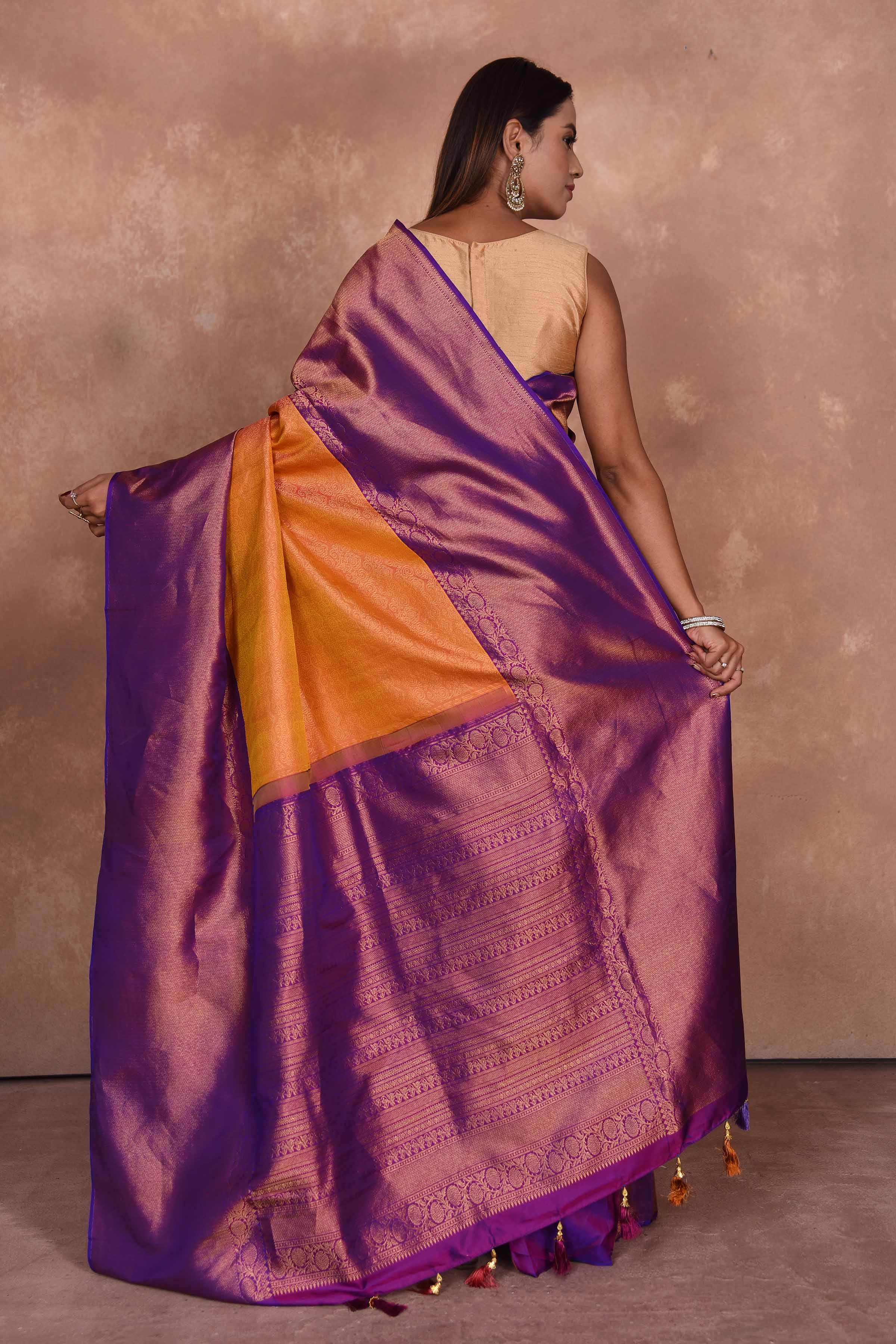 Buy orange Kanjeevaram silk sari online in USA with purple zari border. Keep your ethnic wardrobe up to date with latest designer sarees, pure silk saris, Kanchipuram silk sarees, handwoven sarees, tussar silk saris, embroidered sarees, soft silk sarees, Kora silk sarees from Pure Elegance Indian saree store in USA.-back