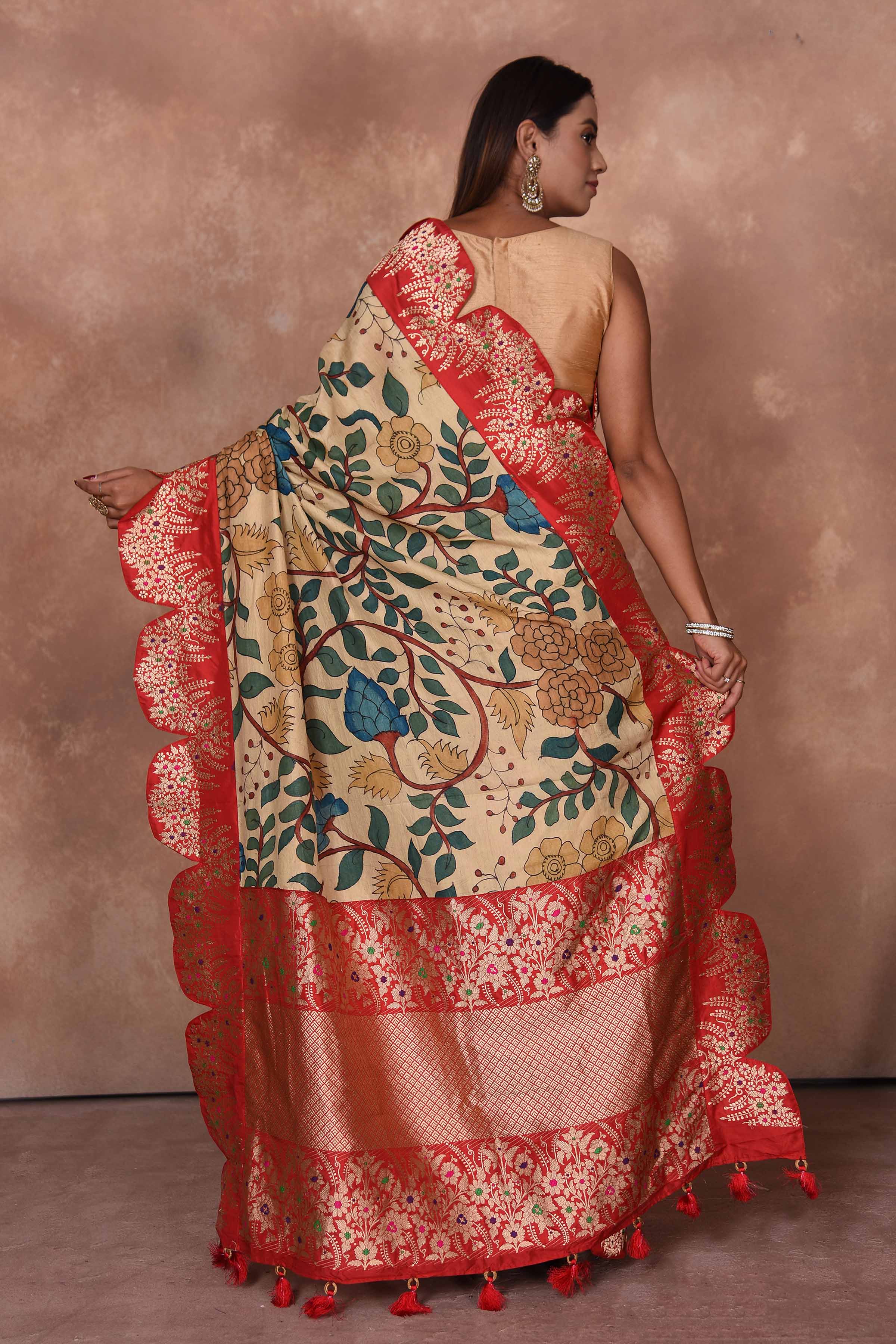 Buy beige Kalamkari Kanjivaram sari online in USA with red scalloped border. Keep your ethnic wardrobe up to date with latest designer sarees, pure silk saris, Kanchipuram silk sarees, handwoven sarees, tussar silk saris, embroidered sarees, soft silk sarees, Kora silk sarees from Pure Elegance Indian saree store in USA.-back