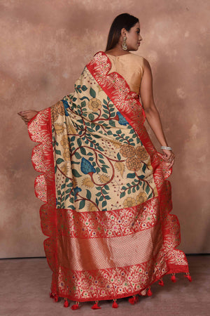 Buy beige Kalamkari Kanjivaram sari online in USA with red scalloped border. Keep your ethnic wardrobe up to date with latest designer sarees, pure silk saris, Kanchipuram silk sarees, handwoven sarees, tussar silk saris, embroidered sarees, soft silk sarees, Kora silk sarees from Pure Elegance Indian saree store in USA.-back
