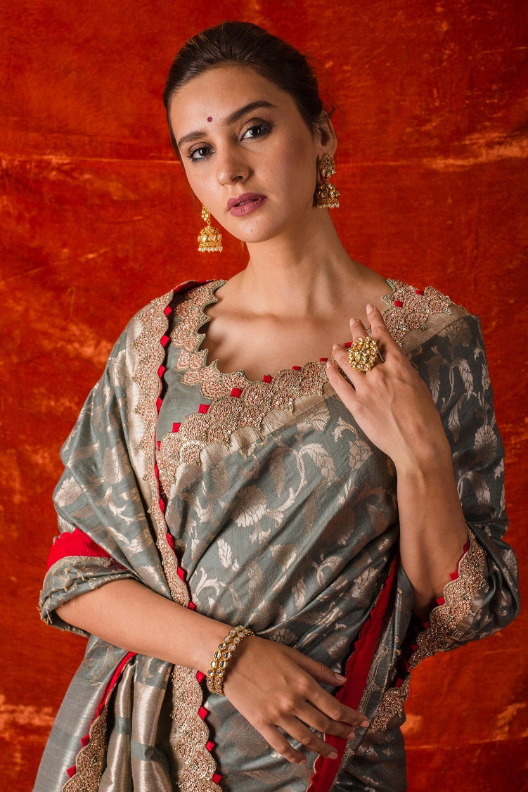 Buy beautiful grey embroidered handloom saree with matching grey blouse online in USA. Saree is crafted with fine embroidery,classsy border,floral design and has a red color touch to it. Be the talk of parties and weddings with exquisite designer sarees from Pure Elegance Indian clothing store in USA.Shop online now.-close up