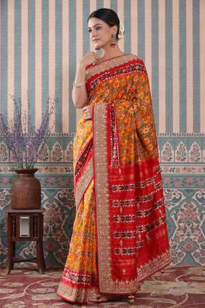 Buy orange Patola silk sari online in USA with red embroidered border. Make a fashion statement at weddings with stunning designer sarees, embroidered sarees with blouse, wedding sarees, handloom sarees from Pure Elegance Indian fashion store in USA.-side