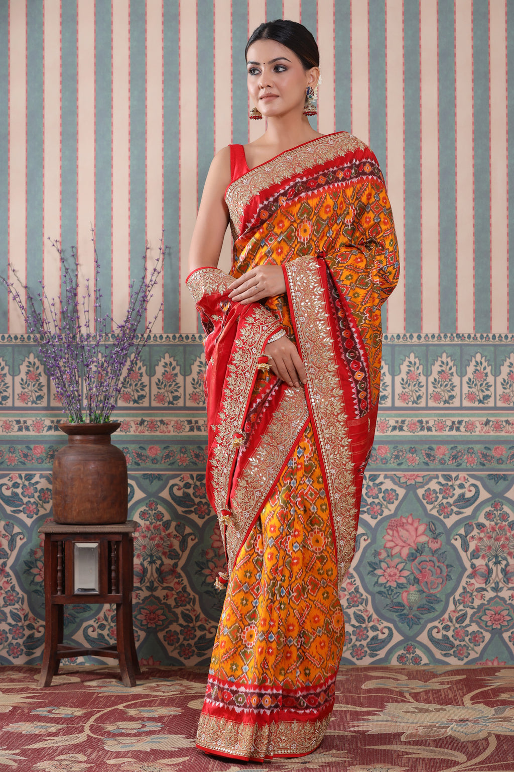 Buy orange Patola silk sari online in USA with red embroidered border. Make a fashion statement at weddings with stunning designer sarees, embroidered sarees with blouse, wedding sarees, handloom sarees from Pure Elegance Indian fashion store in USA.-full view