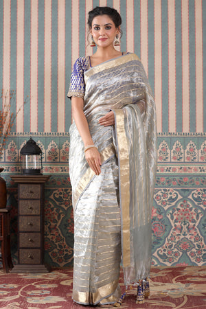Buy grey striped tissue silk sari online in USA with blue saree blouse. Make a fashion statement at weddings with stunning designer sarees, embroidered sarees with blouse, wedding sarees, handloom sarees from Pure Elegance Indian fashion store in USA.-front