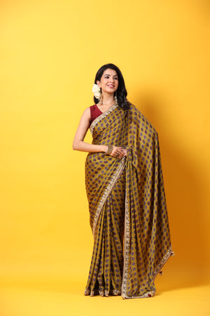 Buy mustard printed georgette sari online in USA with embroidered lace border. Make a fashion statement at weddings with stunning designer sarees, embroidered sarees with blouse, wedding sarees, handloom sarees from Pure Elegance Indian fashion store in USA.-front