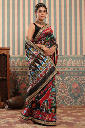 Buy black multicolor Patola sari online in USA with embroidered border. Make a fashion statement at weddings with stunning designer sarees, embroidered sarees with blouse, wedding sarees, handloom sarees from Pure Elegance Indian fashion store in USA.-saree