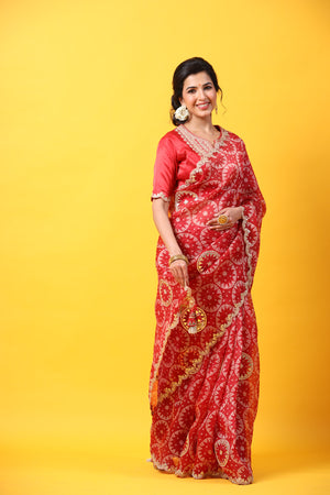 Buy red printed organza sari online in USA with embroidered scalloped border. Make a fashion statement at weddings with stunning designer sarees, embroidered sarees with blouse, wedding sarees, handloom sarees from Pure Elegance Indian fashion store in USA.-side