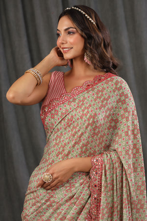 Shop pink green printed georgette saree online in USA with scalloped border. Make a fashion statement at weddings with stunning designer sarees, embroidered sarees with blouse, wedding sarees, handloom sarees from Pure Elegance Indian fashion store in USA.-closeup