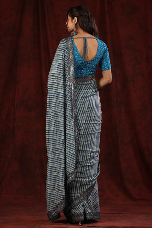 Shop blue stripes crepe saree online in USA with scalloped border. Make a fashion statement at weddings with stunning designer sarees, embroidered sarees with blouse, wedding sarees, handloom sarees from Pure Elegance Indian fashion store in USA.-back