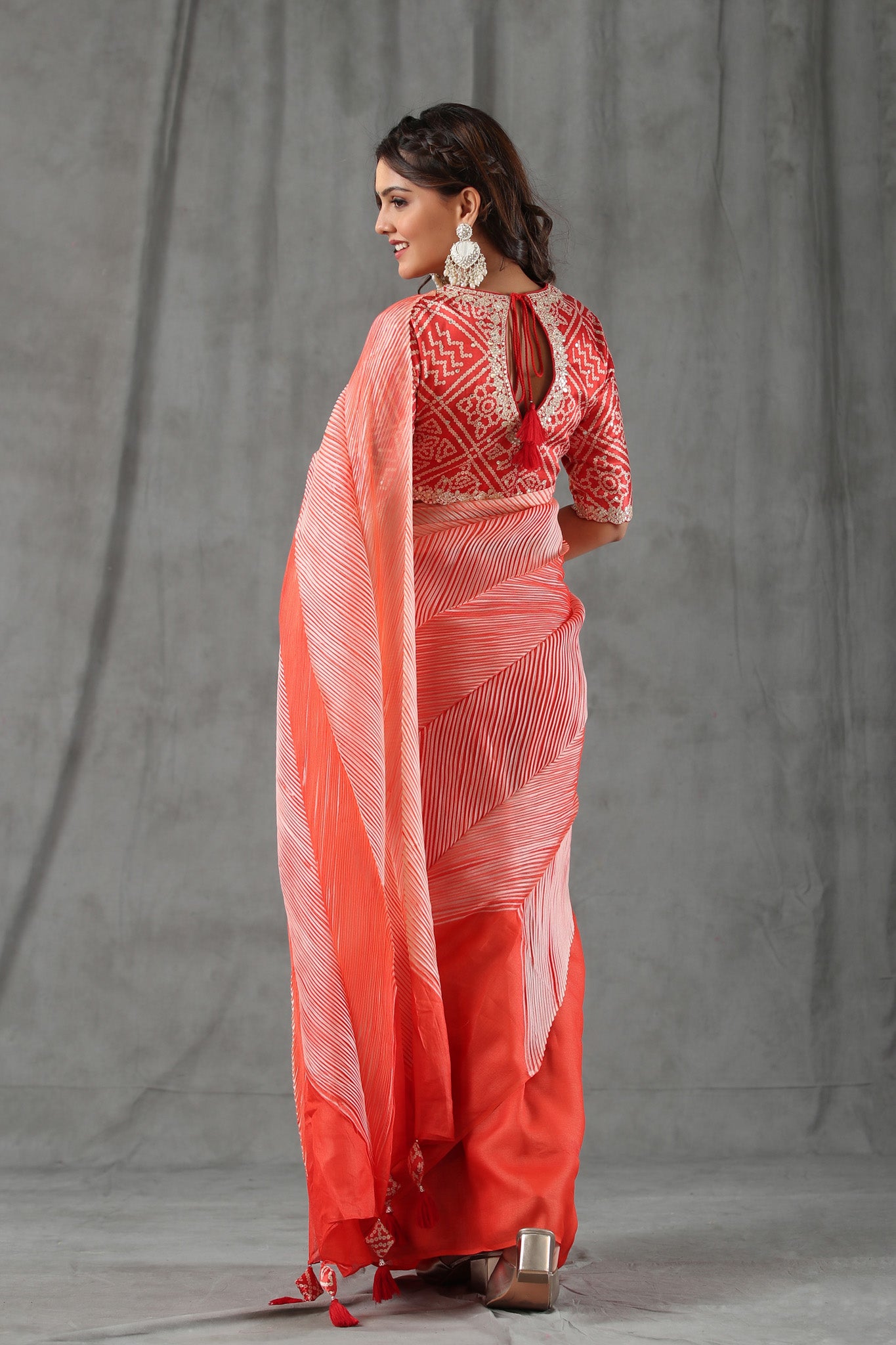 Buy bright red striped tussar silk saree online in USA with bandhej blouse. Make a fashion statement at weddings with stunning designer sarees, embroidered sarees with blouse, wedding sarees, handloom sarees from Pure Elegance Indian fashion store in USA.-back