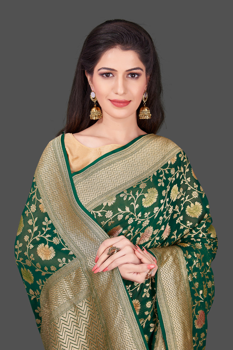 Buy dark green Benarasi georgette sari online in USA with floral zari jaal. Shop beautiful Banarasi georgette sarees, tussar sarees, pure muga silk saris in USA from Pure Elegance Indian fashion boutique in USA. Get spoiled for choices with a splendid variety of Indian sarees to choose from! Shop now.-closeup