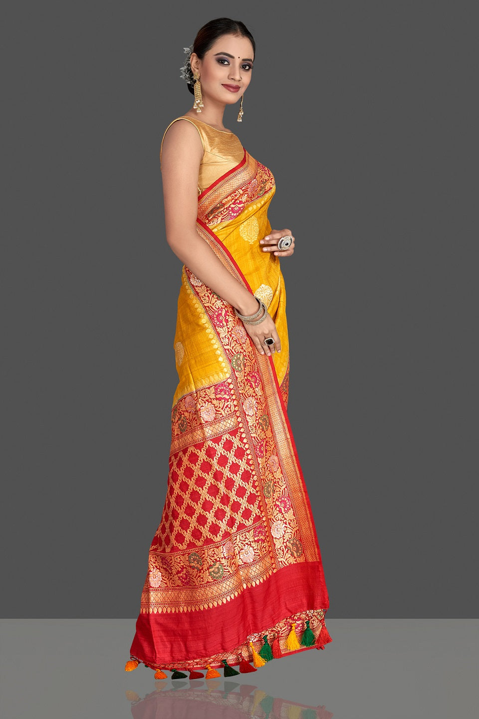 Buy stunning yellow tussar georgette Banarasi saree online in USA with red zari minakari border. Elevate your traditional style with beautiful Banarasi sarees, designer sarees, pure silk sarees, handwoven saris from Pure Elegance Indian saree store in USA.-side
