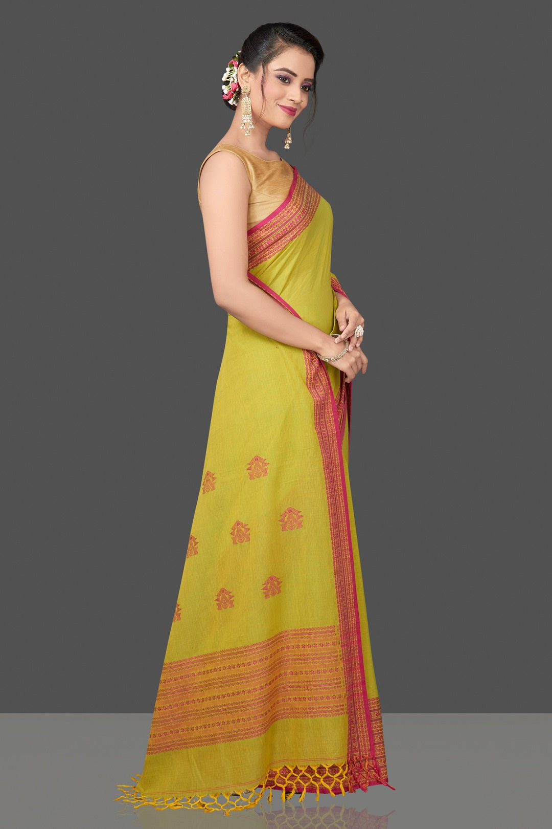 Shop beautiful pista green cotton saree online in USA with pink Assam design pallu. Flaunt Indian fashion in USA with a stunning collection of handwoven sarees, cotton sarees, pure silk sarees, designer saris in USA from Pure Elegance Indian saree store in USA.-side