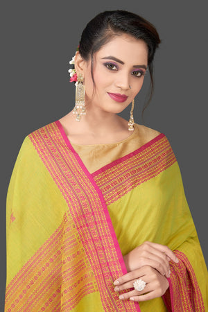 Shop beautiful pista green cotton saree online in USA with pink Assam design pallu. Flaunt Indian fashion in USA with a stunning collection of handwoven sarees, cotton sarees, pure silk sarees, designer saris in USA from Pure Elegance Indian saree store in USA.-closeup