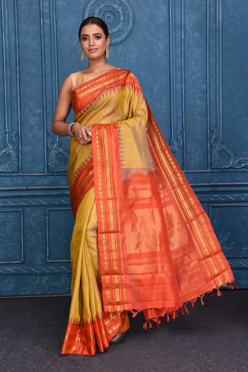 Buy mustard striped pure Gadhwal silk sari online in USA with orange zari border. Keep your ethnic wardrobe up to date with latest designer saris, pure silk sarees, Kanchipuram silk sarees, handwoven silk sarees, tussar silk sarees, embroidered sarees from Pure Elegance Indian saree store in USA.-full view