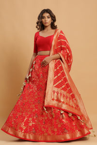 Shop red zari embroidered lehenga with silk dupatta. The lehenga is perfect for a wedding party. It is crafted in silk with intrinsic zari embroidery work all over, tassels on dupatta, and a beautiful plain solid blouse. Shop online from Pure Elegance.