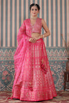 Shop a pink lehenga set featuring a heavy Zari Embroidered Silk Lehenga Set. It comes with a beautiful V-neck blouse and zip closure. It has tassels attached to the lehenga. Pair it with beautiful jewelry to enhance your look. Shop online from Pure Elegance.