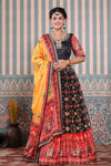Shop a black multicolor lehenga set featuring bhandhej printed silk lehenga set. It comes with a beautiful yellow blouse, gotta pati work red dupatta. Pair it with beautiful jewelry to enhance your look. Shop online from Pure Elegance.