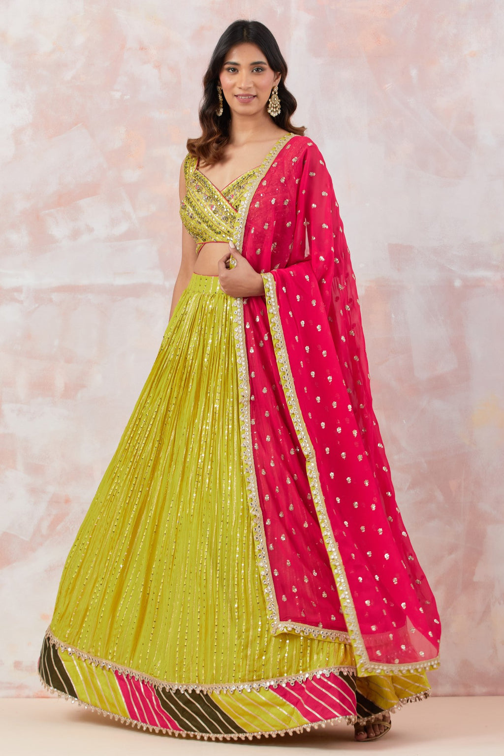 Shop lime green lehenga with a contrasting red dupatta. Dazzle on weddings and special occasions with exquisite Indian designer dresses, sharara suits, Anarkali suits, bridal lehengas, and sharara suits from Pure Elegance Indian clothing store in the USA. Shop online from Pure Elegance.