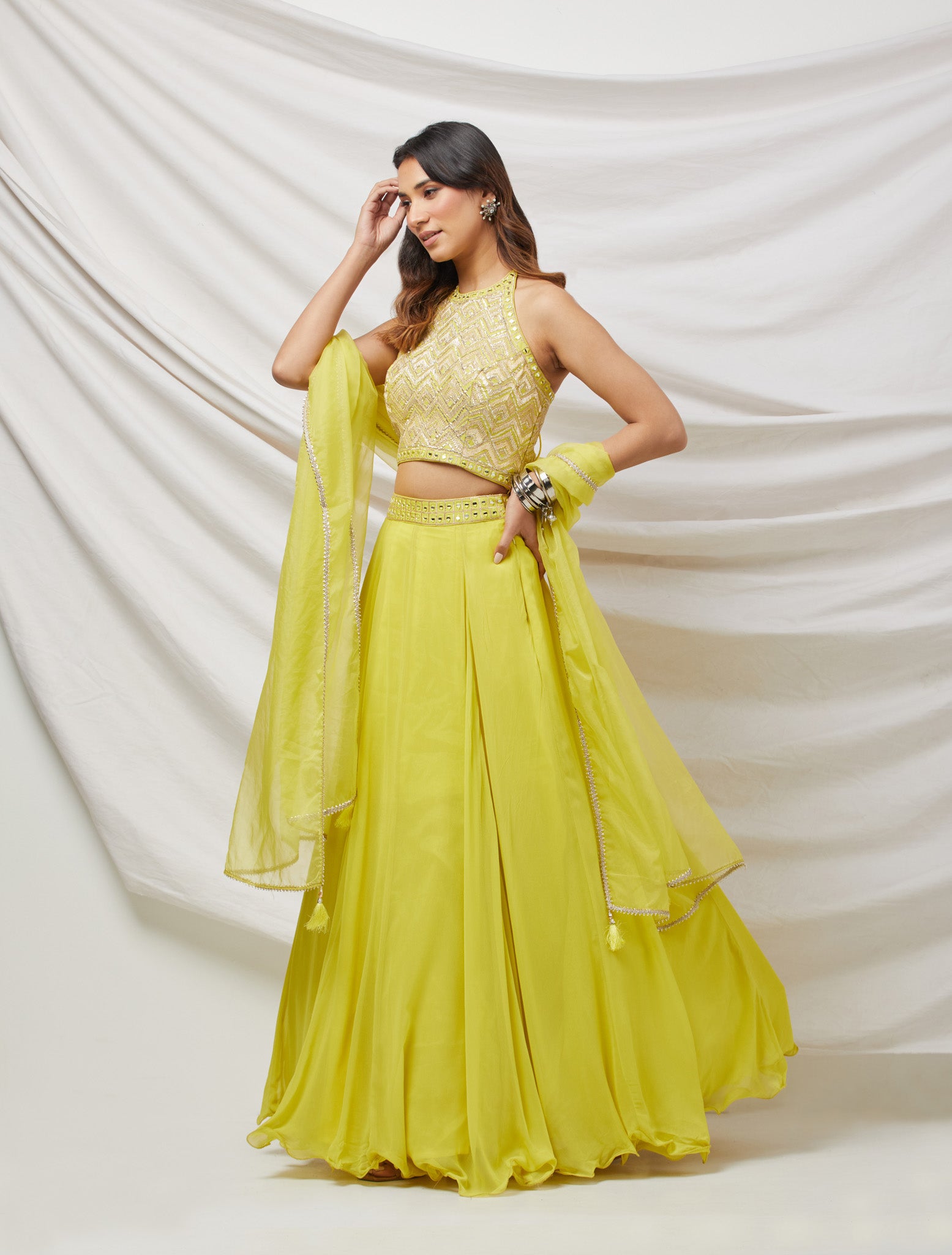 Shop a green lime gotta patti and mirror work lehenga with embroidered blouse & dupatta. Dazzle on weddings and special occasions with exquisite Indian designer dresses, sharara suits, Anarkali suits, bridal lehengas, and sharara suits from Pure Elegance Indian clothing store in the USA. Shop online from Pure Elegance.