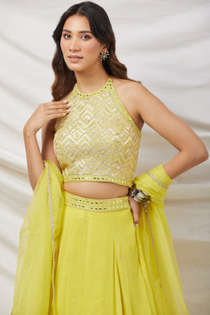 Shop a green lime gotta patti and mirror work lehenga with embroidered blouse & dupatta. Dazzle on weddings and special occasions with exquisite Indian designer dresses, sharara suits, Anarkali suits, bridal lehengas, and sharara suits from Pure Elegance Indian clothing store in the USA. Shop online from Pure Elegance.