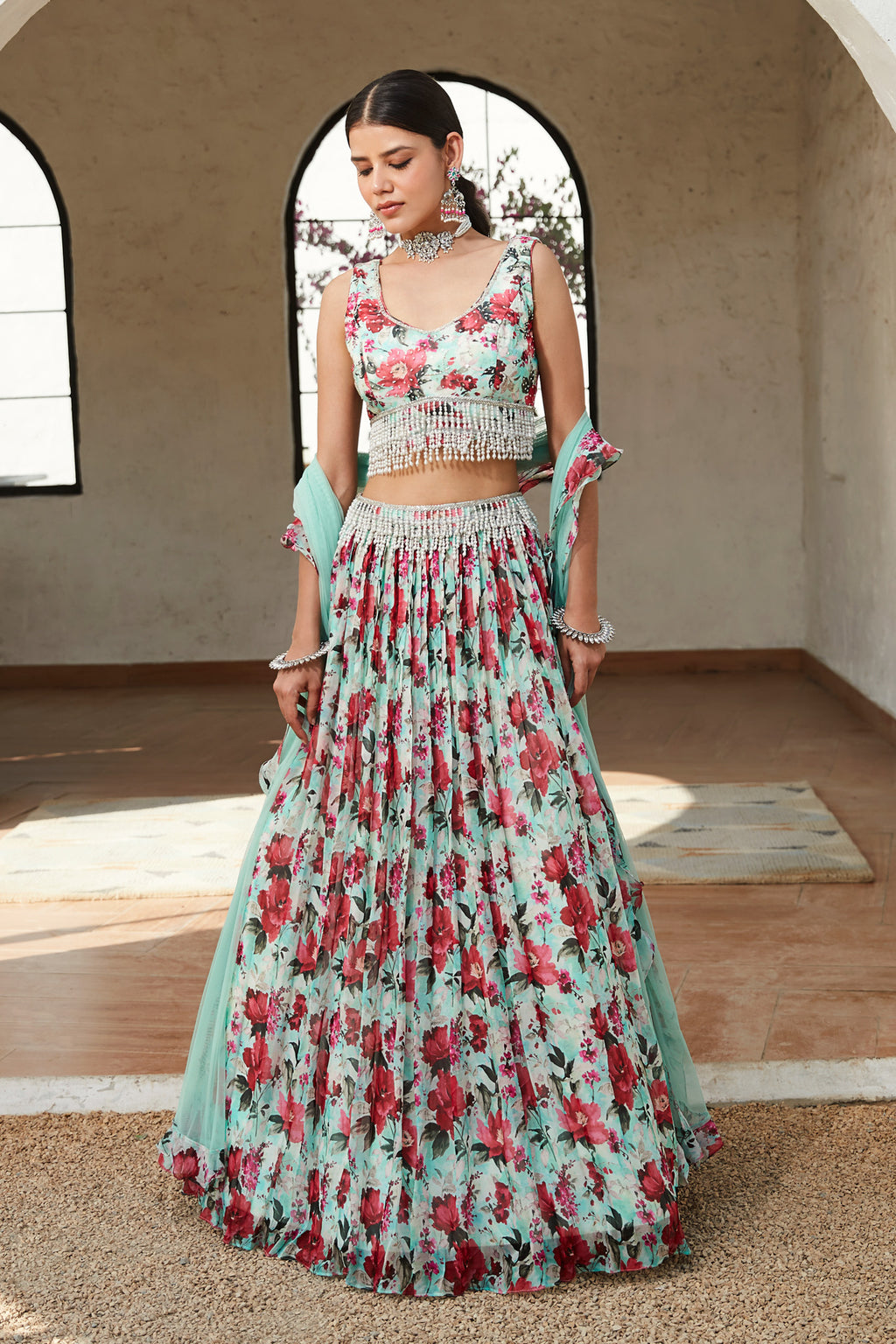 Shop this green floral lehenga comprising halter-neck blouse and a lehenga. Dazzle on weddings and special occasions with exquisite Indian designer dresses, sharara suits, Anarkali suits, bridal lehengas, and sharara suits from Pure Elegance Indian clothing store in the USA. Shop online from Pure Elegance.