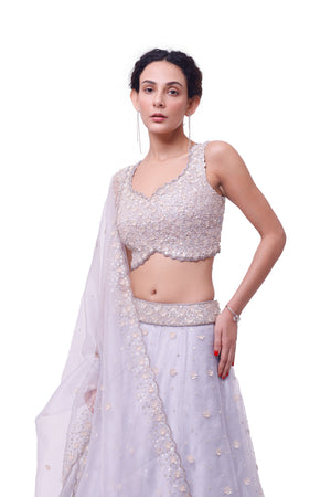 Shop silver tissue embroidered lehenga online in USA with upatta. Dazzle on weddings and special occasions with exquisite designer lehengas, Anarkali suit, sharara suit, Indowestern outfits, bridal lehengas from Pure Elegance Indian clothing store in the USA. -closeup