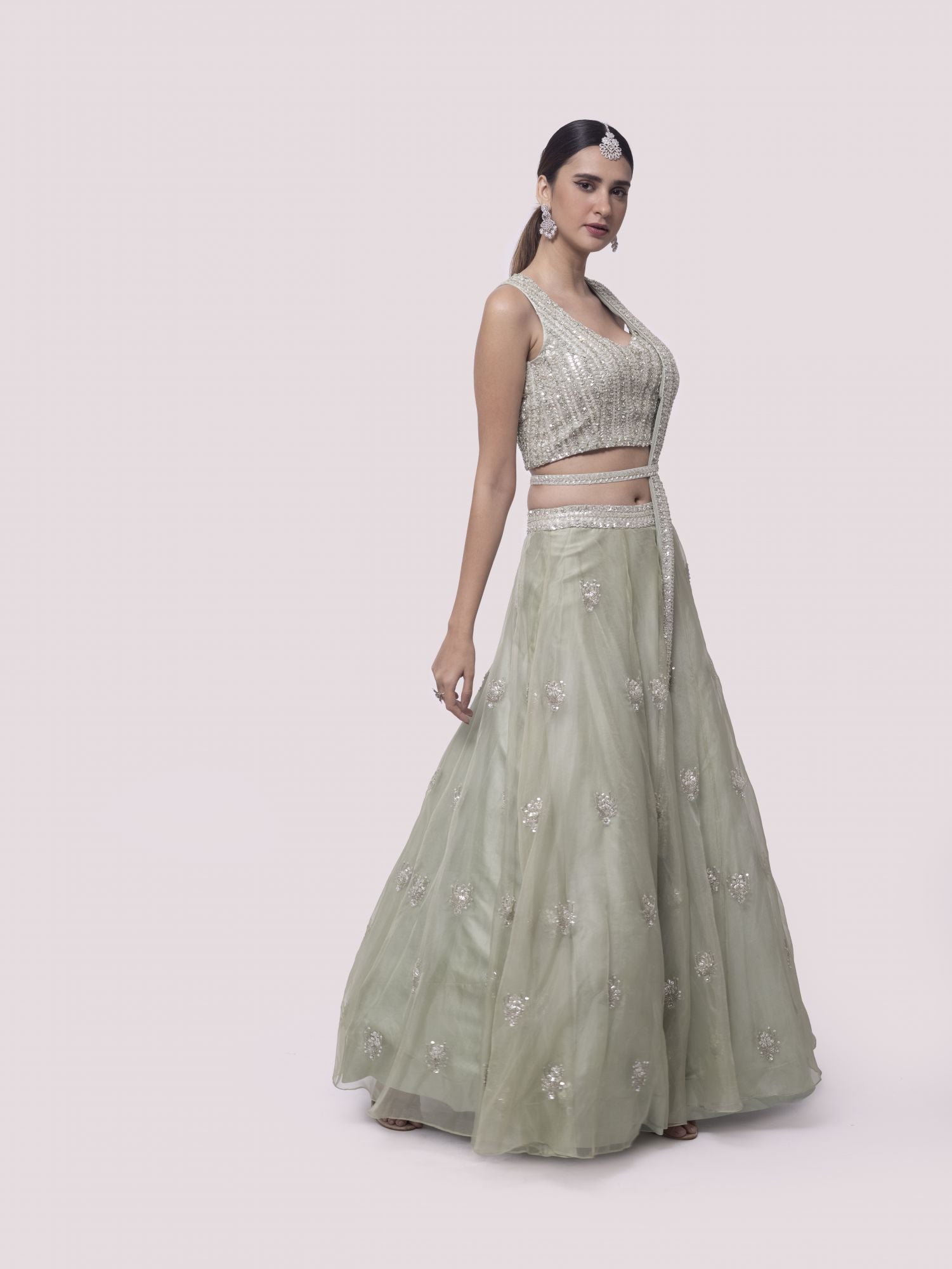 Shop pista green embroidered satin and organza lehenga online in USA with dupatta. Dazzle on weddings and special occasions with exquisite designer lehengas, Anarkali suit, sharara suit, Indowestern outfits, bridal lehengas from Pure Elegance Indian clothing store in the USA. -side