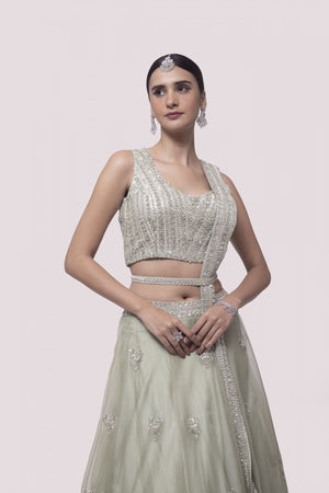 Shop pista green embroidered satin and organza lehenga online in USA with dupatta. Dazzle on weddings and special occasions with exquisite designer lehengas, Anarkali suit, sharara suit, Indowestern outfits, bridal lehengas from Pure Elegance Indian clothing store in the USA. -closeup