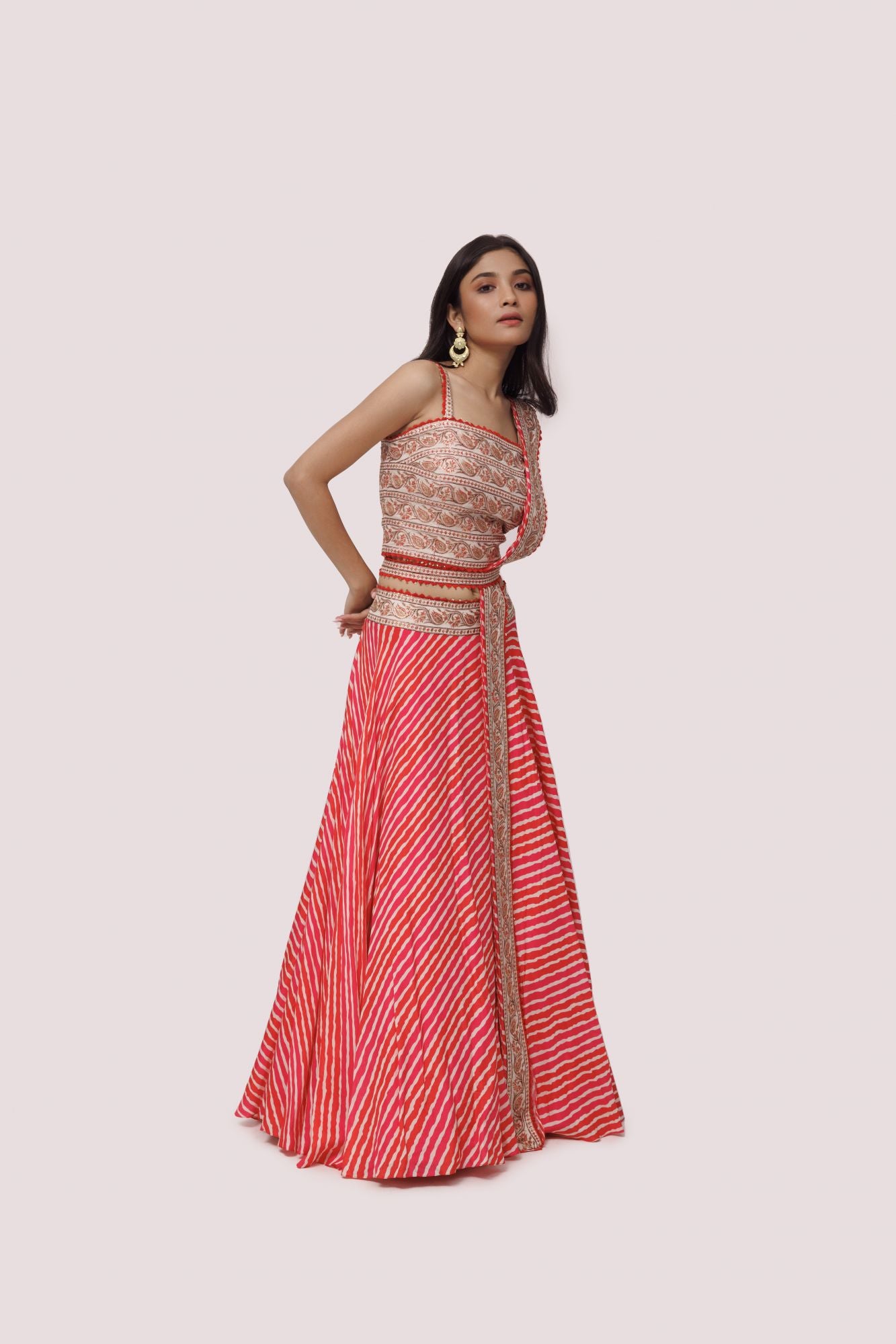 Buy red embroidered silk lehriya lehenga online in USA with belt and thin dupatta. Dazzle on weddings and special occasions with exquisite designer lehengas, Anarkali suit, sharara suit, Indowestern outfits, bridal lehengas from Pure Elegance Indian clothing store in the USA. -side