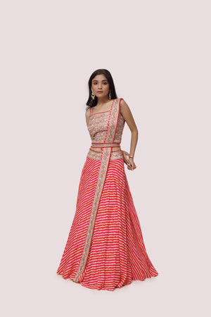 Buy red embroidered silk lehriya lehenga online in USA with belt and thin dupatta. Dazzle on weddings and special occasions with exquisite designer lehengas, Anarkali suit, sharara suit, Indowestern outfits, bridal lehengas from Pure Elegance Indian clothing store in the USA. -lehenga