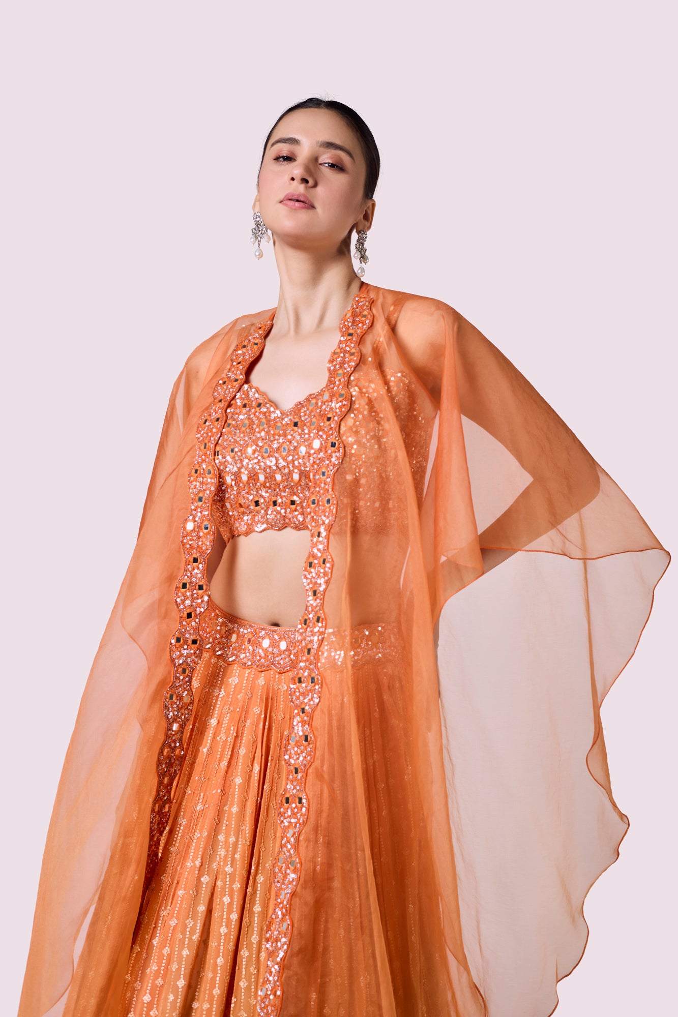 Shop beautiful orange embellished chikan lehenga online in USA with dupatta. Shop the best and latest designs in embroidered sarees, designer sarees, Anarkali suit, lehengas, sharara suits for weddings and special occasions from Pure Elegance Indian fashion store in USA.-closeup