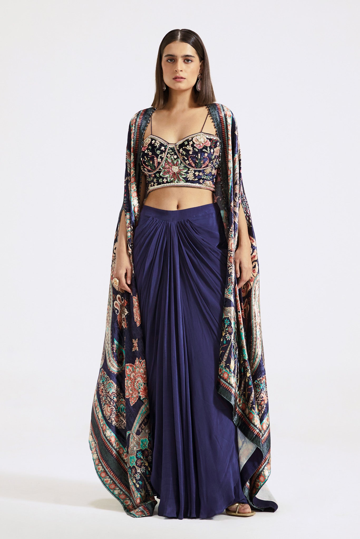 Buy blue velvet and crepe draped skirt set online in USA with printed cape. Shop the best and latest designs in embroidered sarees, designer sarees, Anarkali suit, lehengas, sharara suits for weddings and special occasions from Pure Elegance Indian fashion store in USA.-full view