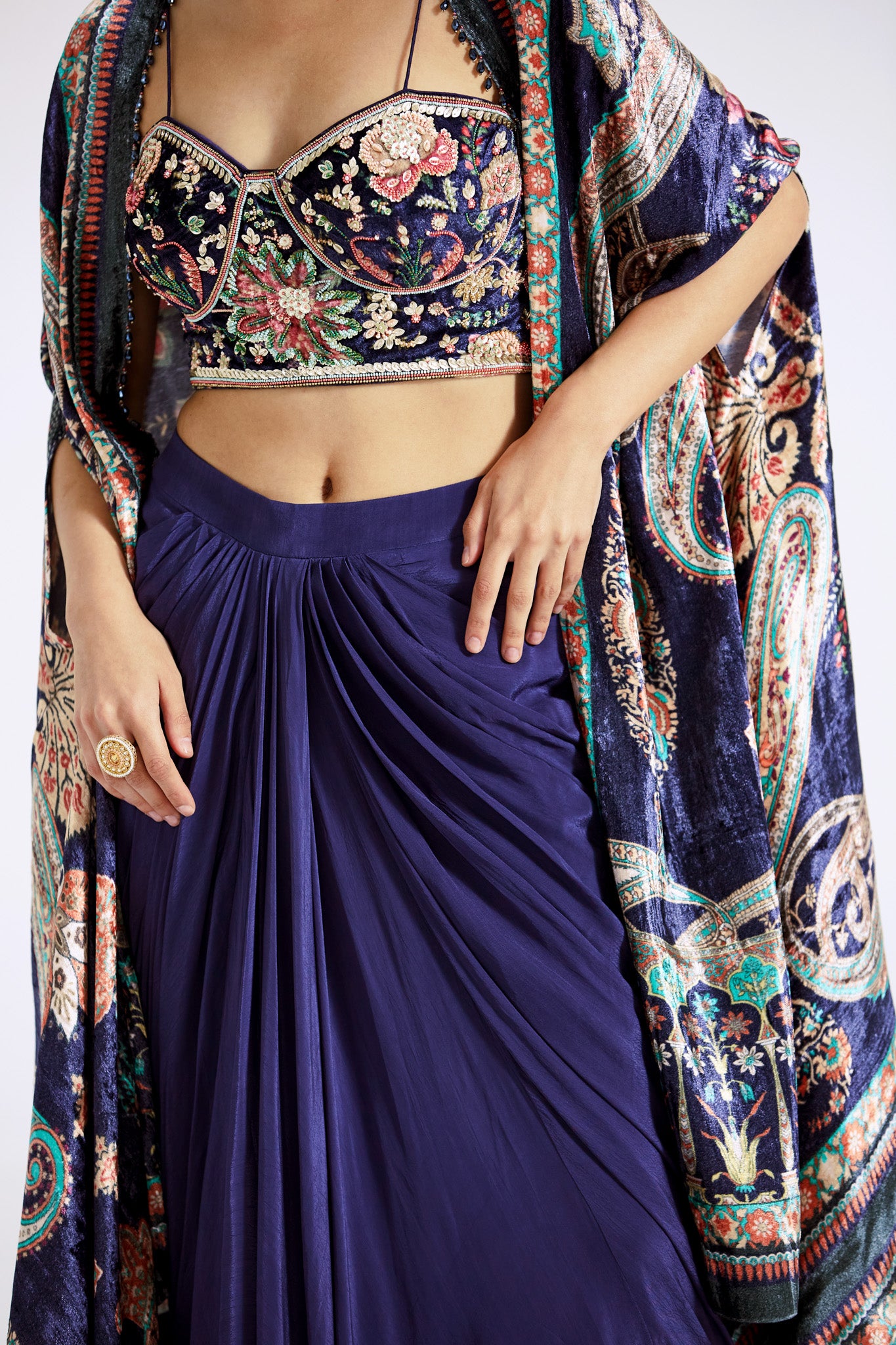 Buy blue velvet and crepe draped skirt set online in USA with printed cape. Shop the best and latest designs in embroidered sarees, designer sarees, Anarkali suit, lehengas, sharara suits for weddings and special occasions from Pure Elegance Indian fashion store in USA.-skirt