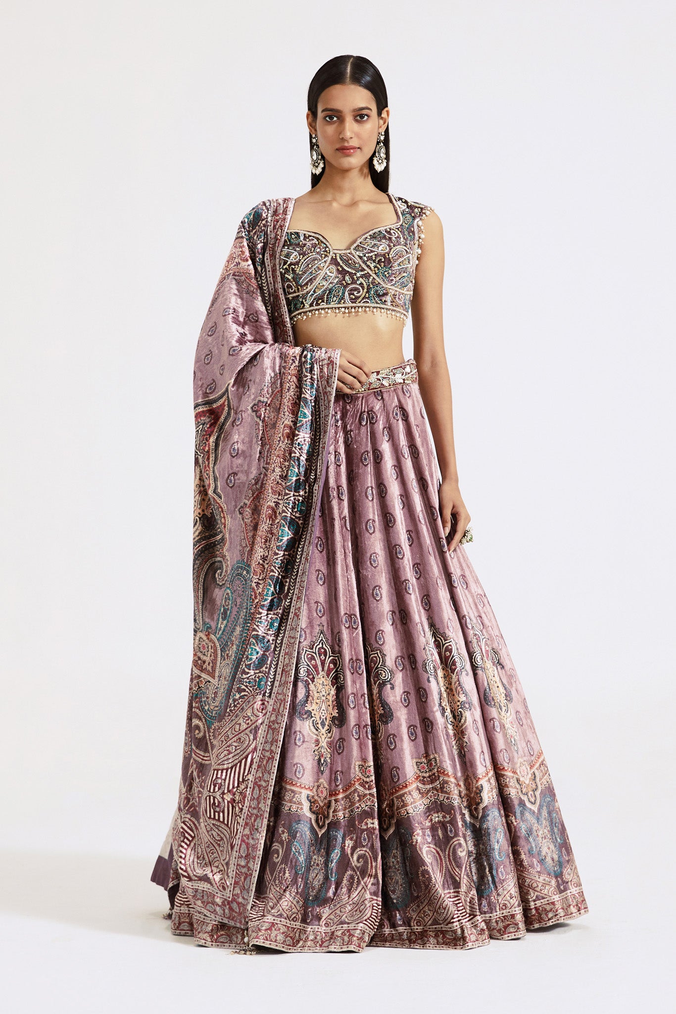 Shop onion pink printed and embroidered velvet lehenga online in USA. Shop the best and latest designs in embroidered sarees, designer sarees, Anarkali suit, lehengas, sharara suits for weddings and special occasions from Pure Elegance Indian fashion store in USA.-full view