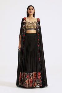 Buy black applique work skirt and bustier set online in USA with cape. Shop the best and latest designs in embroidered sarees, designer sarees, Anarkali suit, lehengas, sharara suits for weddings and special occasions from Pure Elegance Indian fashion store in USA.-full view