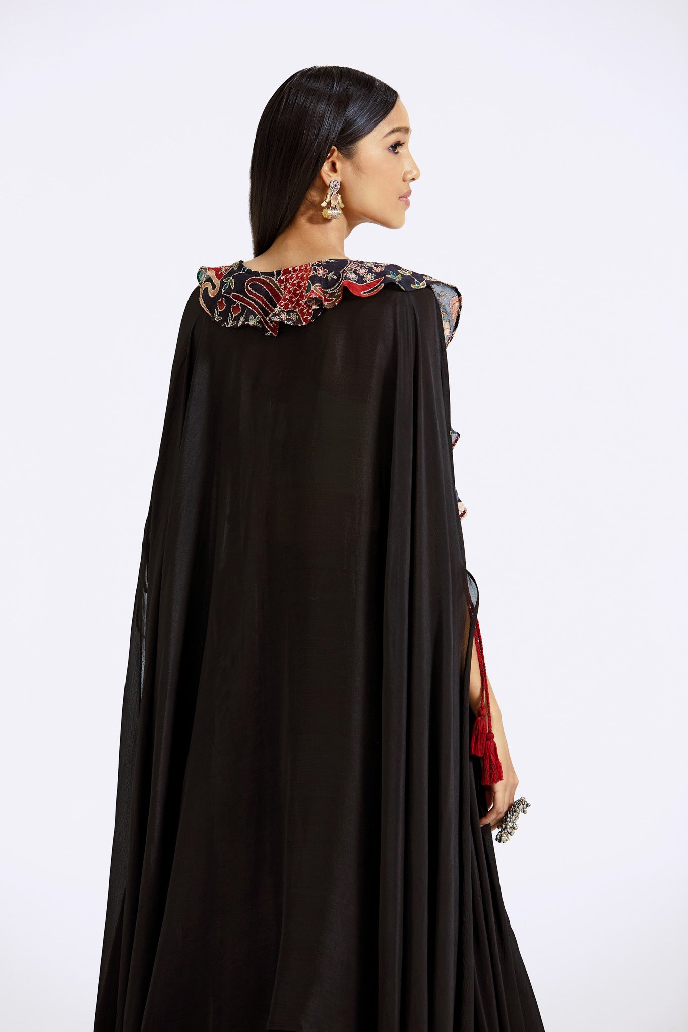 Buy black applique work skirt and bustier set online in USA with cape. Shop the best and latest designs in embroidered sarees, designer sarees, Anarkali suit, lehengas, sharara suits for weddings and special occasions from Pure Elegance Indian fashion store in USA.-back