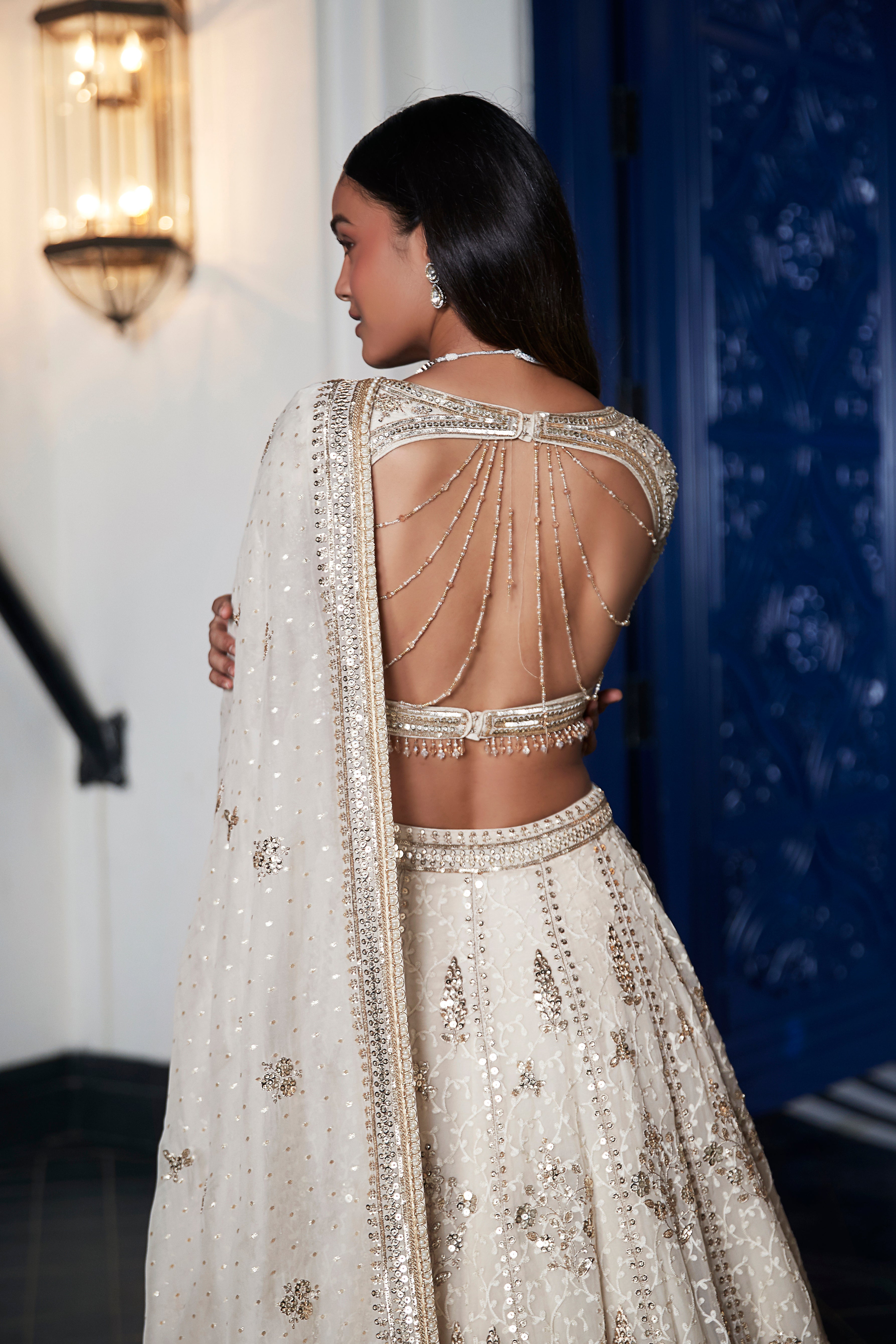 Shop ivory embroidered organza lehenga online in USA with dupatta. Shop the best and latest designs in embroidered sarees, designer sarees, Anarkali suit, lehengas, sharara suits for weddings and special occasions from Pure Elegance Indian fashion store in USA.-back
