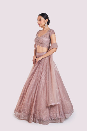 Buy beautiful onion pink embroidered net lehenga online in USA with dupatta. Shop the best and latest designs in embroidered sarees, designer sarees, Anarkali suit, lehengas, sharara suits for weddings and special occasions from Pure Elegance Indian fashion store in USA.-lehenga