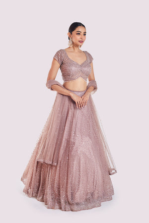 Buy beautiful onion pink embroidered net lehenga online in USA with dupatta. Shop the best and latest designs in embroidered sarees, designer sarees, Anarkali suit, lehengas, sharara suits for weddings and special occasions from Pure Elegance Indian fashion store in USA.-side